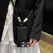Person wearing a black wallet phone case with a lanyard, holding a phone.