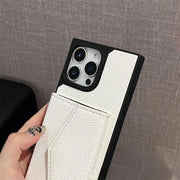 White phone case with textured finish held by a hand against a gray background