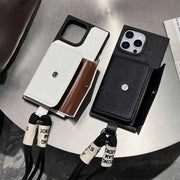 Two wallet phone cases with lanyards on a metallic surface