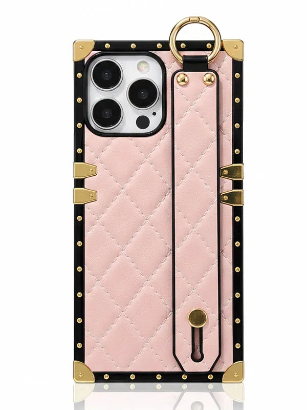 Pink quilted phone case with had strap on a white background