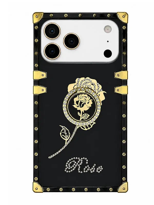 A black phone case with gold-tone metal corner protectors and rivets, featuring a gold rose illustration in a circular frame and the word 'Rose' in rhinestone-style script near the bottom.