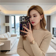 Woman taking a mirror selfie in a modern living room