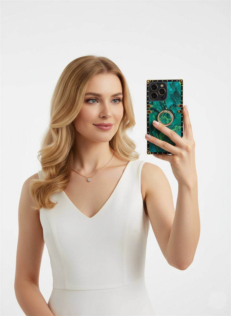 Woman holding a phone with a green and black case against a white background