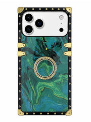 A protective phone case featuring a green and teal marbled pattern, framed by a black border with gold-tone rivets and corner protectors, and a central circular ring stand embellished with small clear stones.