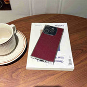 glitter Phone case on a magazine with a cup on a saucer next to it on a wooden table.