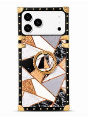 A protective phone case with a geometric mosaic pattern featuring black, white, gray, and rose gold marble textures, accented with gold-tone studs, corner protectors, and a central circular ring stand.
