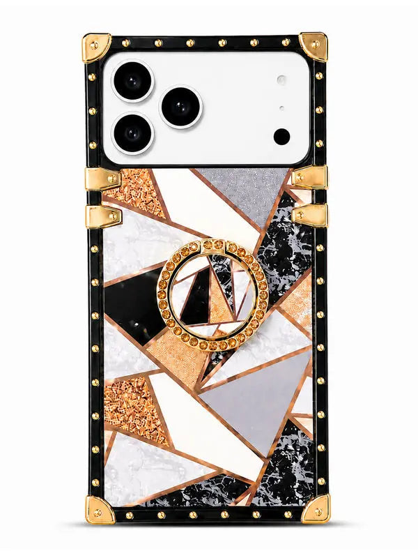 A protective phone case with a geometric mosaic pattern featuring black, white, gray, and rose gold marble textures, accented with gold-tone studs, corner protectors, and a central circular ring stand.