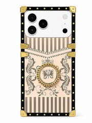 A protective phone case with a vintage-inspired design, featuring a black border with gold studs and corner protectors, beige and brown stripes, a central butterfly medallion, and a gold kickstand.