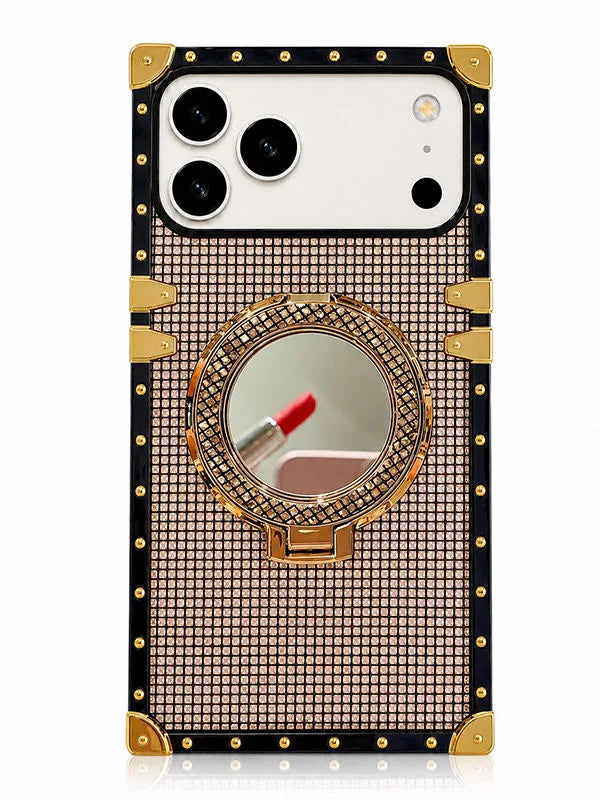 A luxury-style smartphone case with a black border, gold corner protectors and hinges, and a central round mirror set in a rhinestone-embellished gold and pink grid pattern. The case is shown on a white phone against a clean white background.