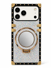 A luxury phone case featuring a rhinestone-embellished back cover, a built-in circular mirror on a kickstand, and gold-tone metal corner protectors and trim.