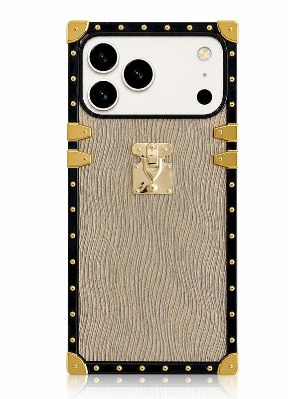 A luxury-style phone case designed to look like a vintage trunk, featuring a beige wood-grain textured center, a black border, gold-tone rivets, corner protectors, and a central gold clasp, shown on a white background.