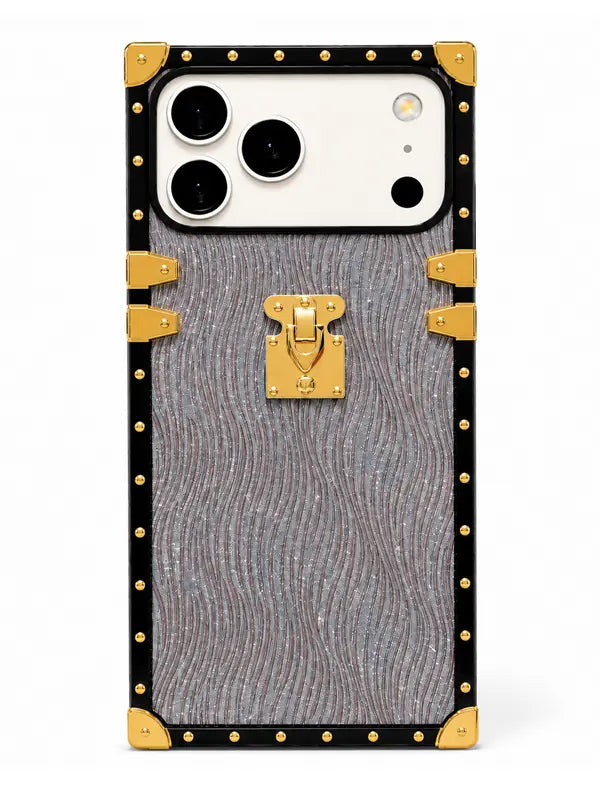 A luxury-style phone case designed to look like a vintage trunk, featuring a textured gray wavy pattern, black trim, gold-tone studs, corner protectors, and a central gold clasp, shown on a white background.