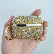 Hand holding the gold Glittery AirPods Case with matching ring clip