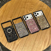 Four glittery phone cases on a wooden surface
