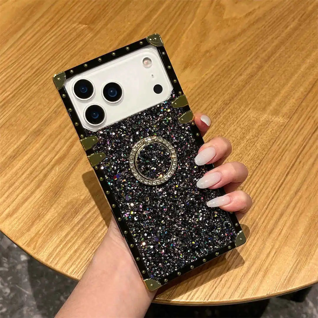 square-trunk Phone case with glittery design held by a hand on a wooden surface