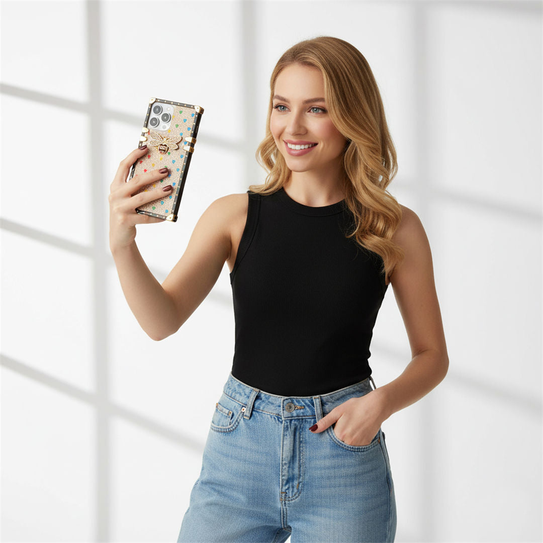 a woman is holding a phone in gold bling phone case