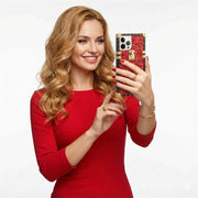 Woman in a red dress holding a smartphone with a decorative case against a white background