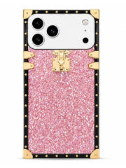 A protective phone case designed for a Google Pixel, featuring a pink glitter center panel with a gold-trimmed lock design and a black outer border with gold studs.