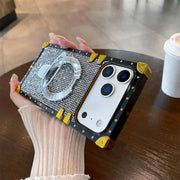 Silver Phone case with ring holder held by a hand on a wooden surface