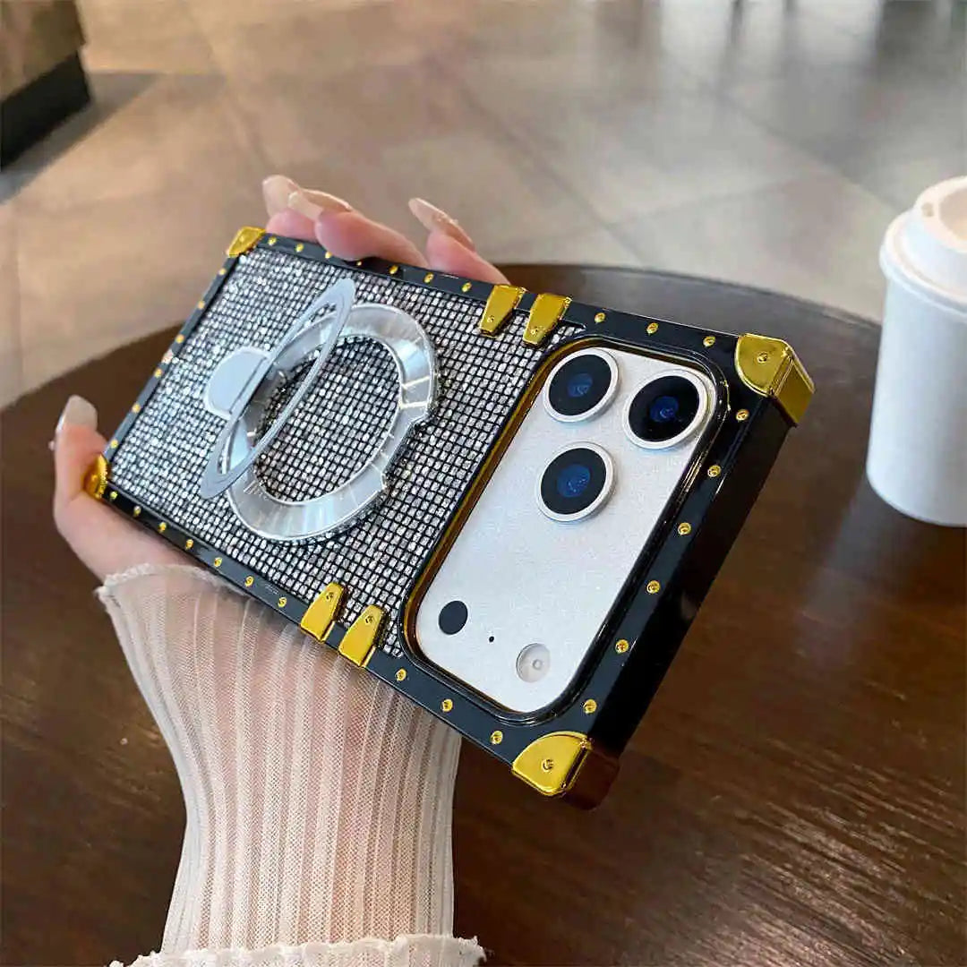 Silver Phone case with ring holder held by a hand on a wooden surface