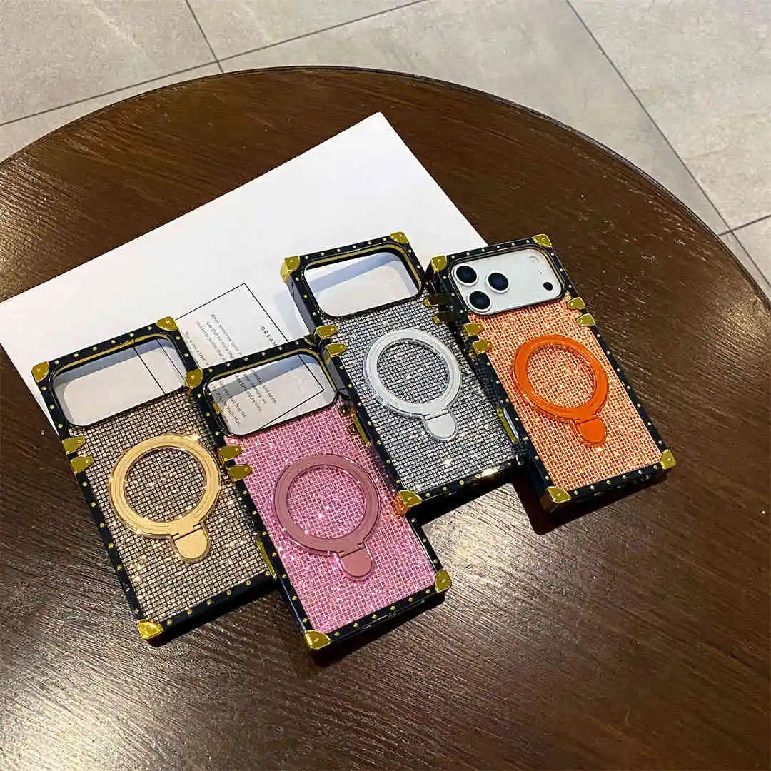 glitter iPhone 17 pro max phone cases with ring stand on a wooden surface