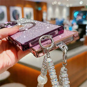 Phone case with decorative elements held by a hand in an indoor setting
