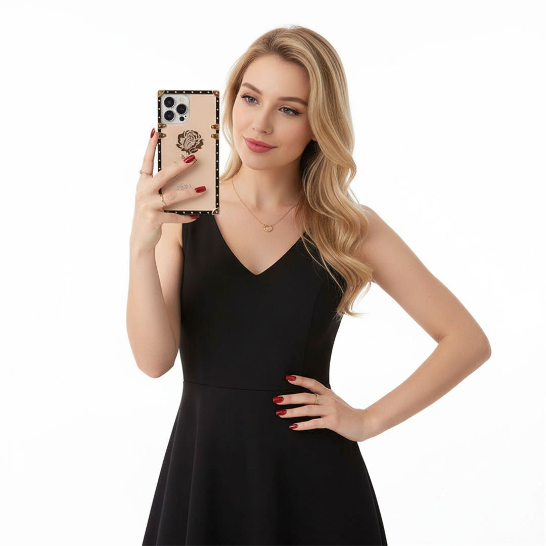 Woman in a black dress holding a phone with a leopard print case on a white background