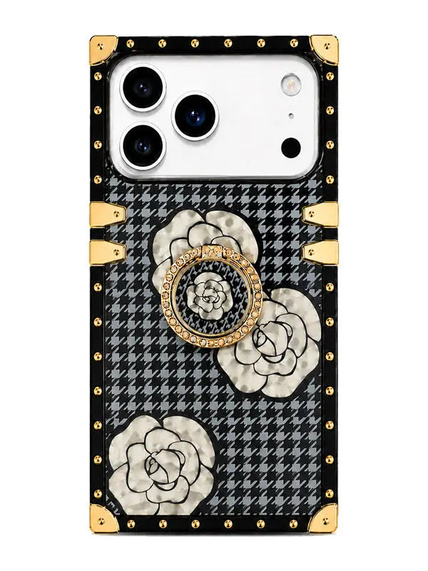 A luxury-style phone case featuring a black and gray houndstooth pattern, large white rose illustrations, gold-tone rivets, corner protectors, and a circular rose-shaped PopSocket holder in the center.