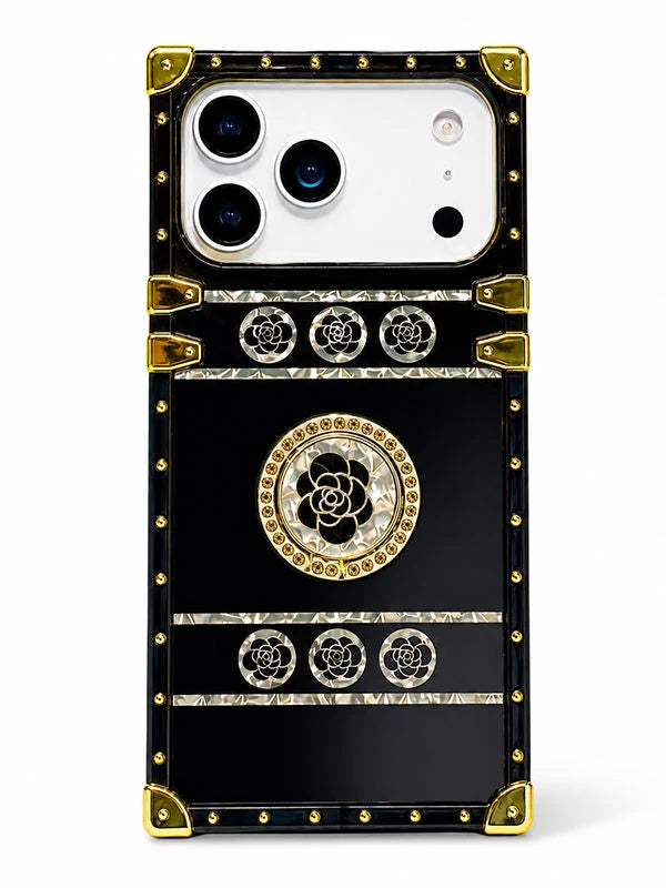 A luxury-style black phone case with gold-tone rivets, corner protectors, and rose motifs, shown on a white background.
