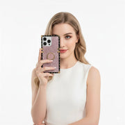 Woman holding a phone with a decorative case against a white background