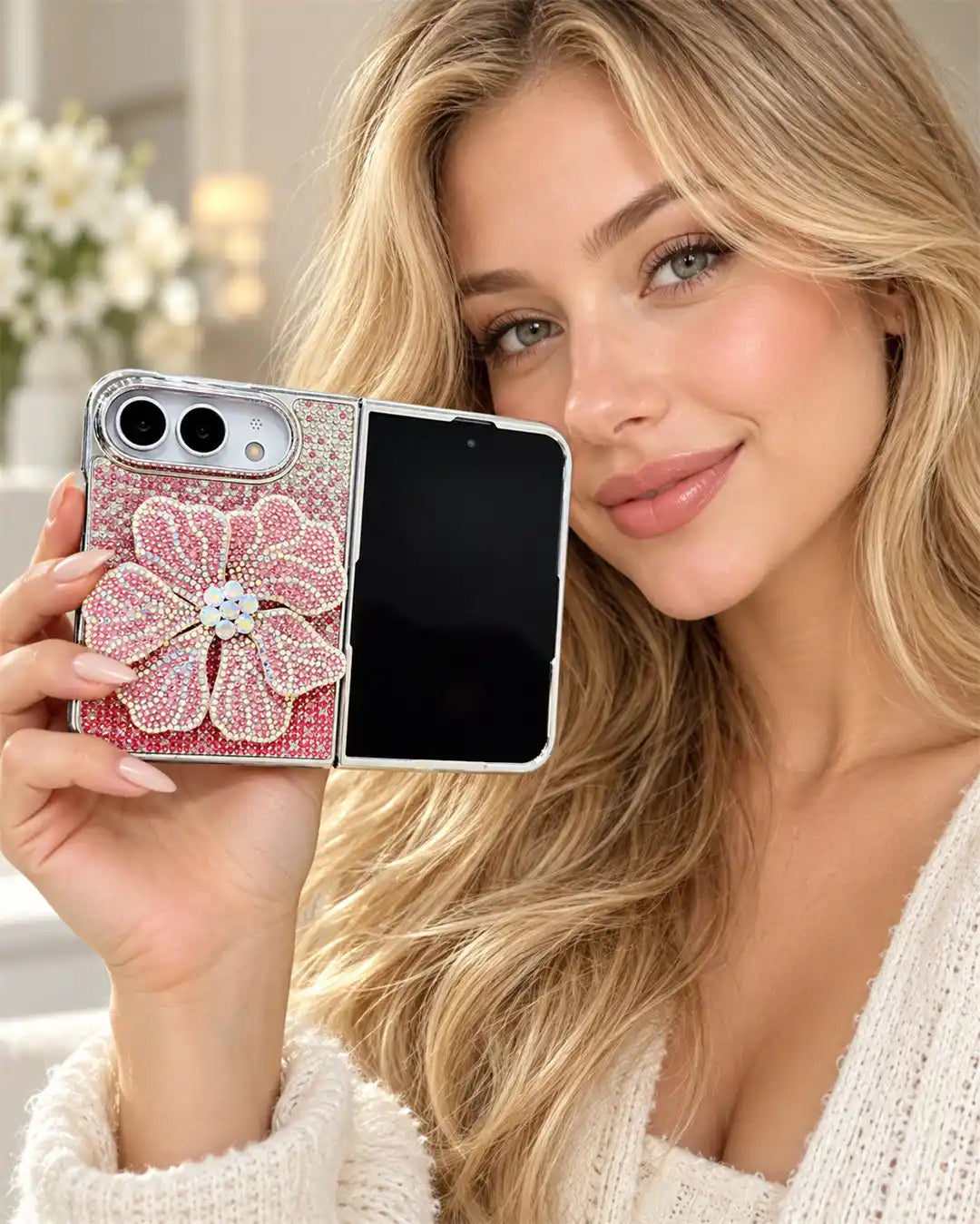 Woman holding an open iPhone Duo in the pink Crystal Bloom Duo flower case near her face