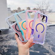 Four transparent phone cases with colorful geometric designs held by a hand outdoors.