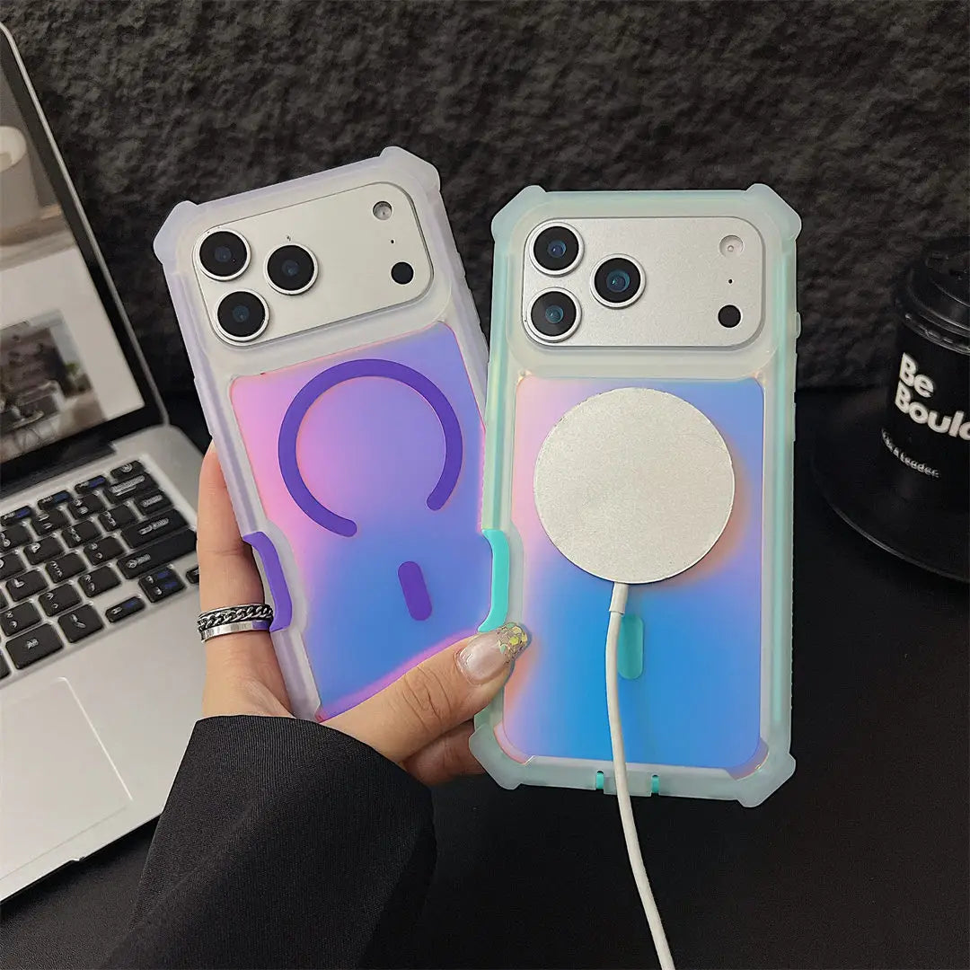 Two phone cases with glowing effects held by a hand, with a laptop and mug in the background.