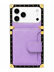 A purple faux-saffiano leather phone case with a snap-button flap pocket, featuring a black studded border with gold-tone metal corner protectors, shown on a white smartphone against a white background.