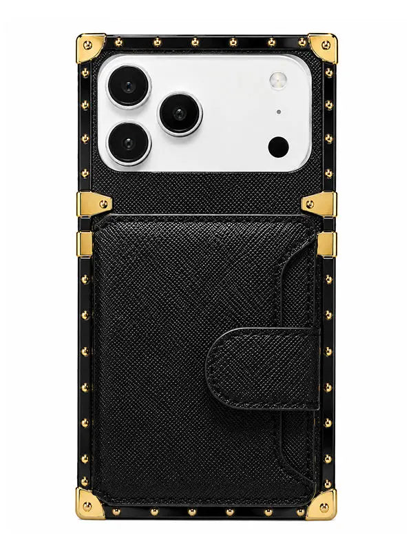 A black textured phone case with gold-tone metal corner protectors and studs, featuring a large front card pocket and a white camera cutout, shown on a plain white background.