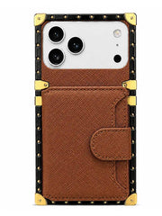 A brown textured faux leather phone case with a snap-button flap, designed for a Google Pixel. The case features a black border with gold-tone metal studs and corner protectors, and a horizontal card slot pocket on the front.
