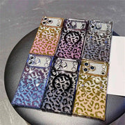Collection of square leopard print phone cases on a dark surface