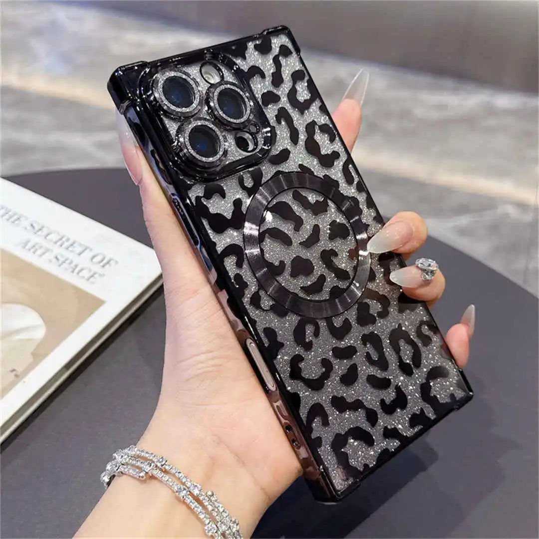 Hand holding a phone with a leopard print case on a reflective surface