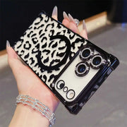 Phone case with leopard print design held by a hand