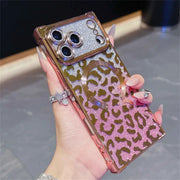 Square phone case with pink glittery leopard print design held by a hand.