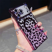 Phone case with leopard print and purple glittery design held by a hand.