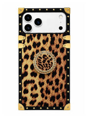 A protective phone case featuring a leopard print pattern, black trim, gold-tone studs, and a central circular pop-out stand with a leopard print center and a jeweled border.