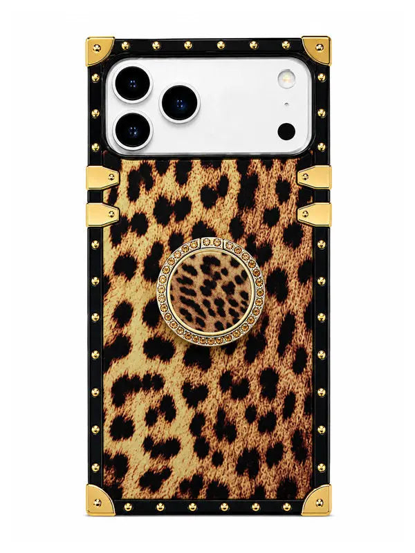 A protective phone case featuring a leopard print pattern, black trim, gold-tone studs, and a central circular pop-out stand with a leopard print center and a jeweled border.