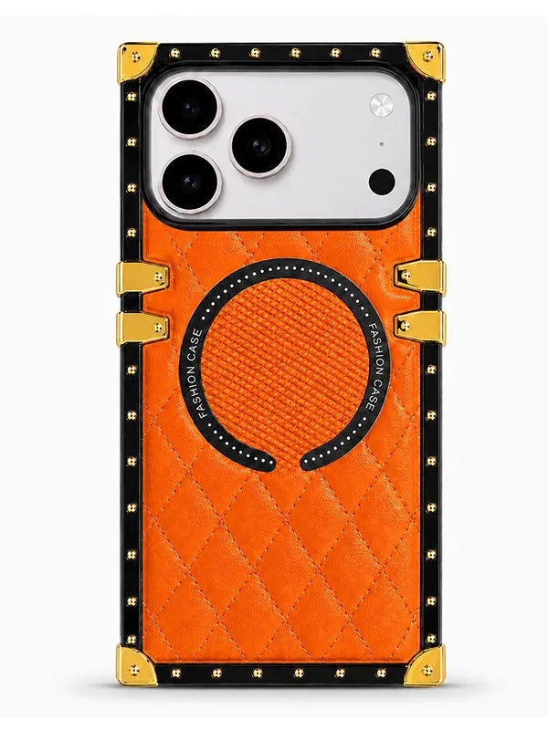 An orange quilted phone case with a black and gold frame, featuring a circular magnetic ring on the back.