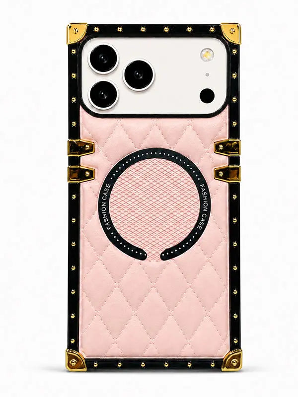 A light pink quilted phone case with a black border, gold-tone corner protectors and hinges, and a circular magnetic ring on the back, shown on a white phone against a light gray background.