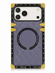 A protective phone case with a quilted lavender-purple back, black trim, gold-tone corner protectors and studs, and a circular magnetic ring on the back.