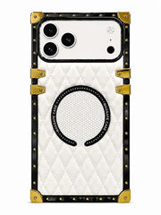 A luxury-style phone case with a white quilted leather back, black border, gold-tone rivets, and corner protectors, featuring a circular magnetic ring on the back.