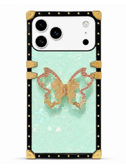 A protective phone case designed for a Samsung Galaxy Ultra, featuring a black studded border, a light mint green textured background, and a central rose gold glitter butterfly accent.