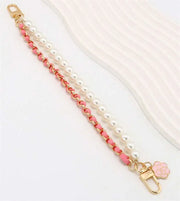 Pearl and pink chain strap with a decorative clasp on a white background