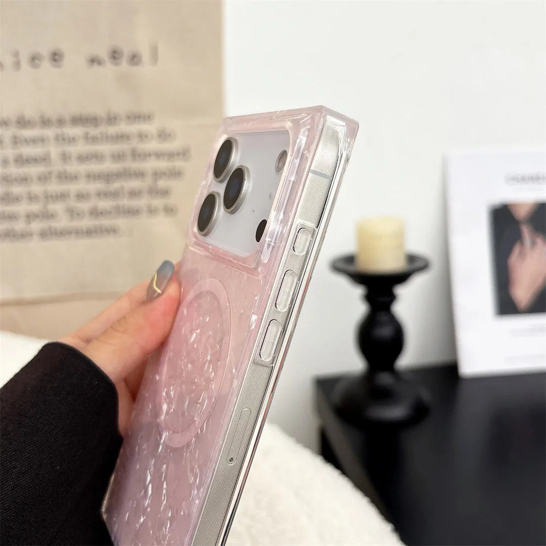 Phone case with glittery pink design held by a hand, blurred background